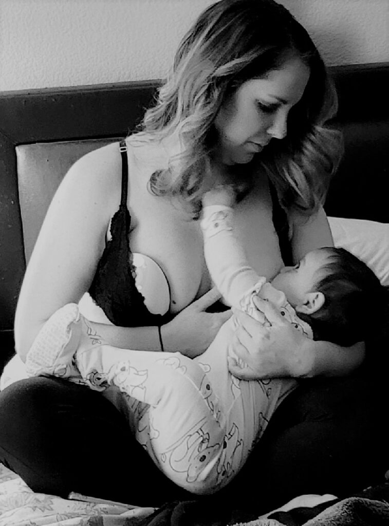 Postpartum woman breastfeeding baby