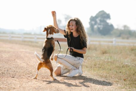 Excited woman training a dog: work from home with a puppy