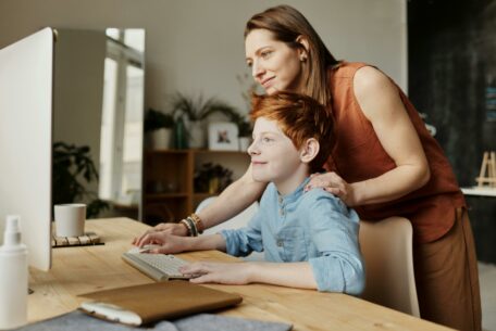 photo of woman teaching son while smiling: teach your kids skills