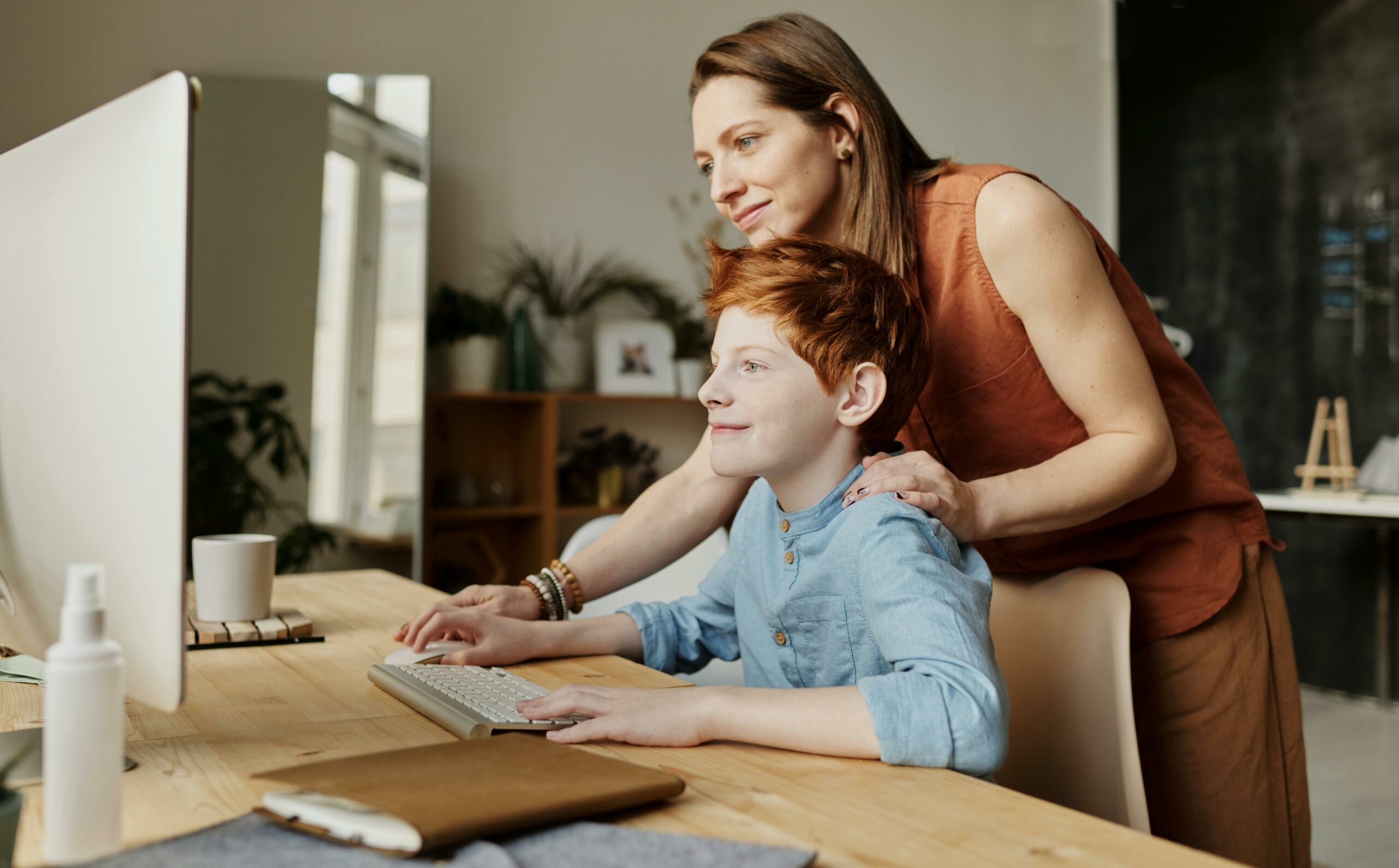 photo of woman teaching son while smiling: teach your kids skills