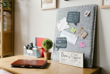 At-home office set up with corkboard of reminders and signs: art of multi-tasking